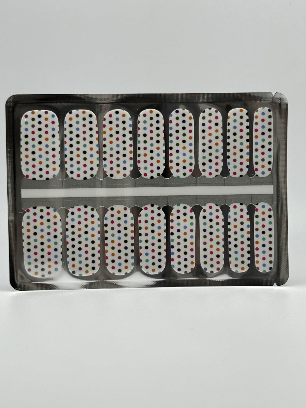 Full set white polka dot nail wraps in packaging showing classic manicure design strips