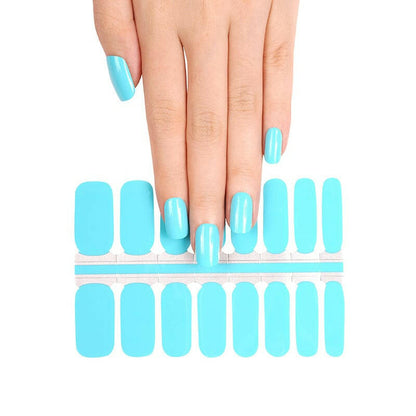 Bright blue nail wraps sheet with hands showing turquoise manicure for DIY nail art