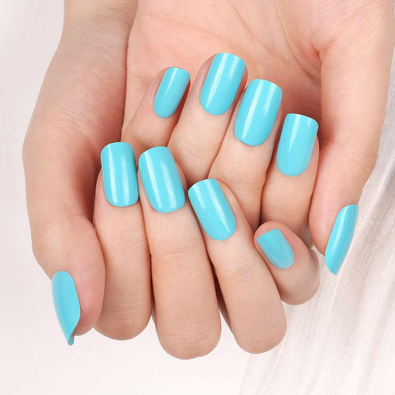 Bright blue glossy gel nail wraps displayed on both hands for at-home manicure