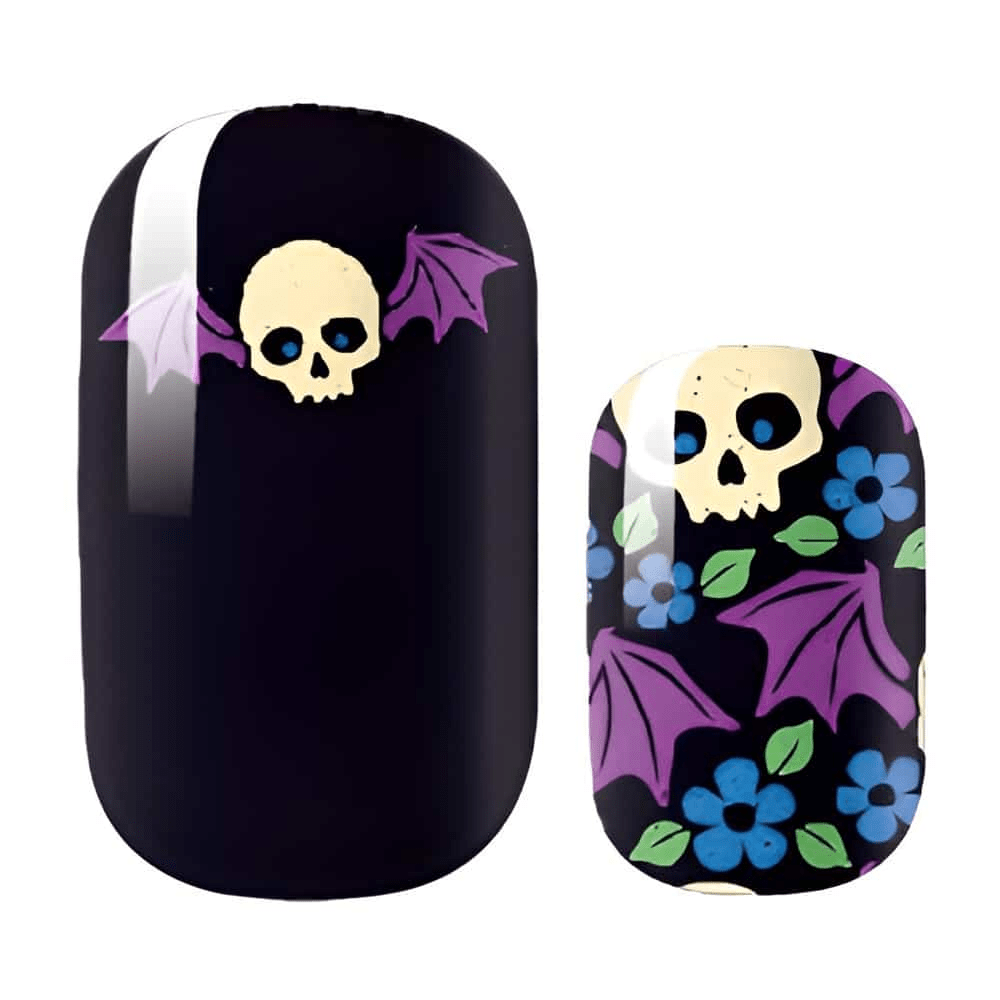 Black nail wraps with purple bat wings and cream skull gothic Halloween nail art design