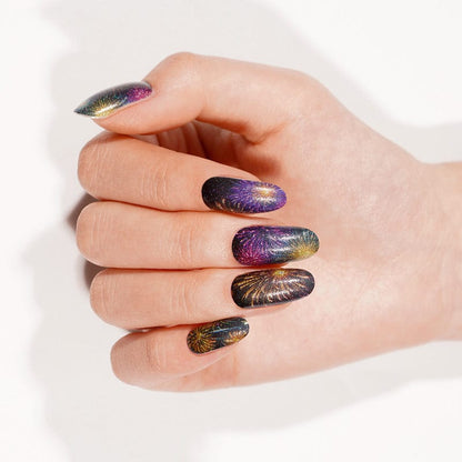 Purple gold firework pattern gel nail wraps on hand for bonfire night manicure