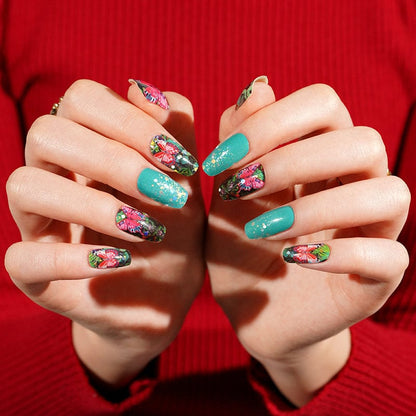 Vibrant floral nail wraps on hands showing botanical garden pattern with butterfly motifs