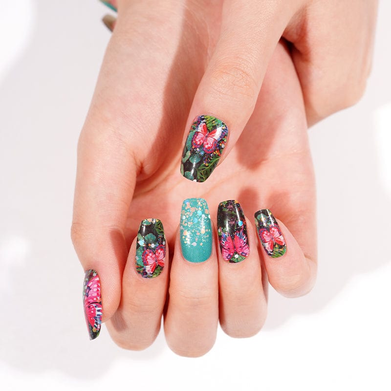 Colourful floral nail art wraps on hand featuring botanical garden design with turquoise accents