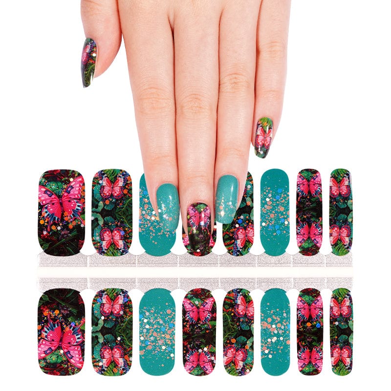Hand wearing botanical floral nail wraps with teal glitter accents showing finished manicure look