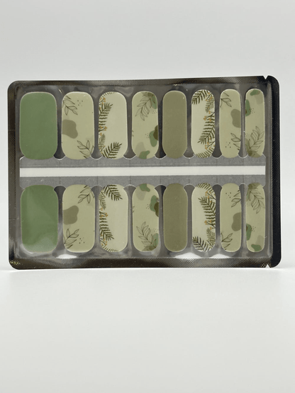 Green botanical leaf pattern nail wraps displayed in packaging showing nature-inspired nail art design