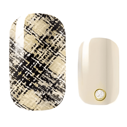 Black and gold textured nail wraps with cream accent nail featuring geometric pattern