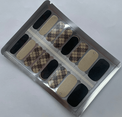 Beige tweed pattern nail wraps with black accents and glitter finish for classic manicure