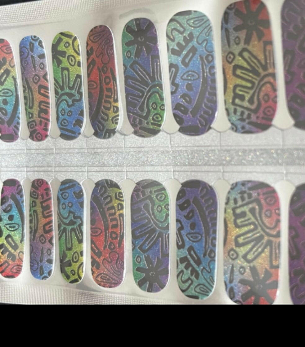 Colourful geometric pattern nail wraps with tribal designs in rainbow gradients