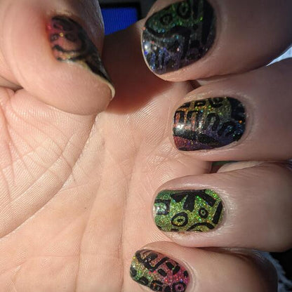 Colourful glitter nail wraps on hand showing vibrant rainbow holographic pattern design