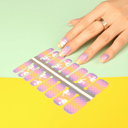 Non-UV nail wraps featuring cute white rabbits on purple orange gradient background