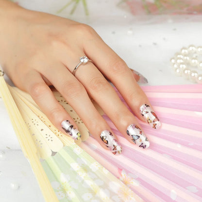 White nail wraps with colourful butterfly pattern on hand showing manicure