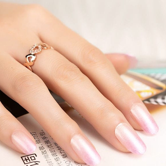 Glossy pink ombre gel nail wraps on hand, gradient manicure for at-home nail art