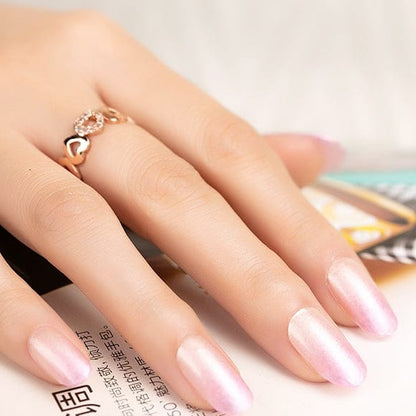 Glossy pink ombre gel nail wraps on hand, gradient manicure for at-home nail art