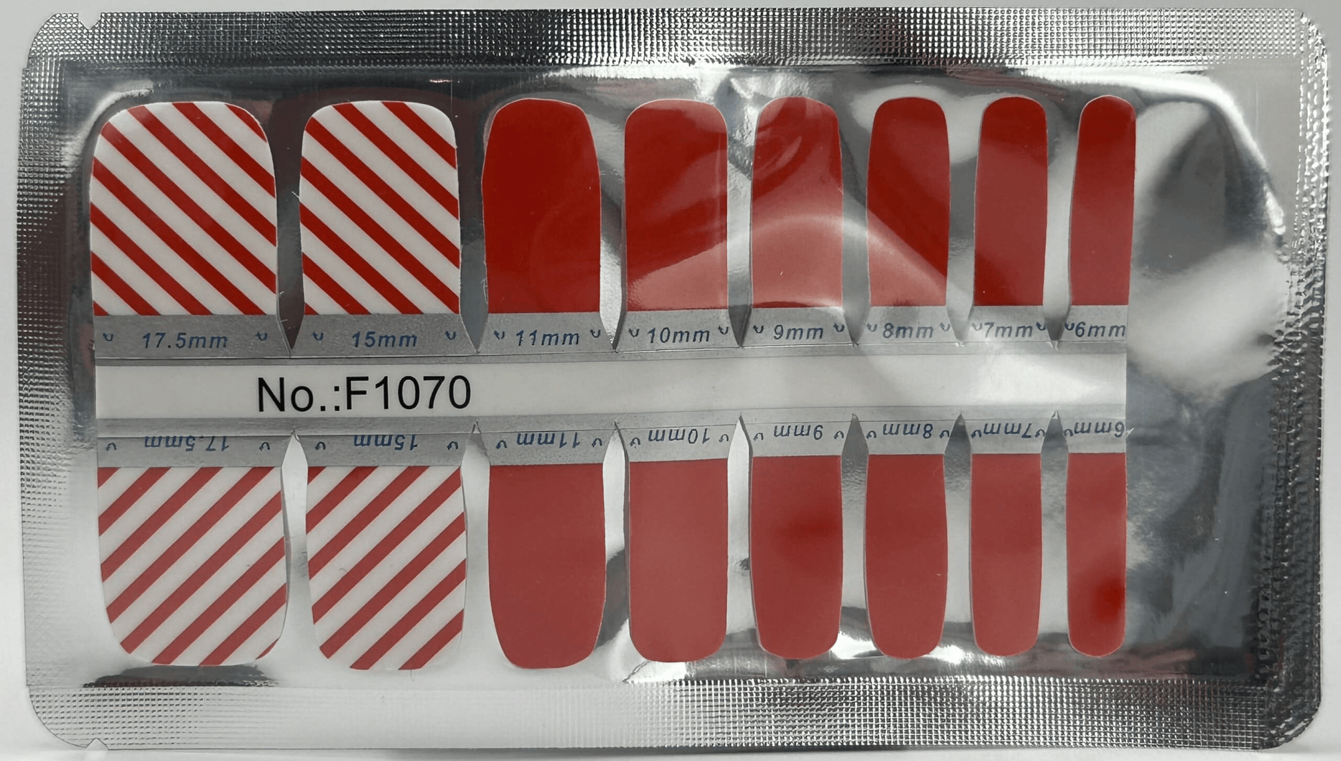 Red and white striped pedicure nail wraps sheet showing candy cane pattern designs
