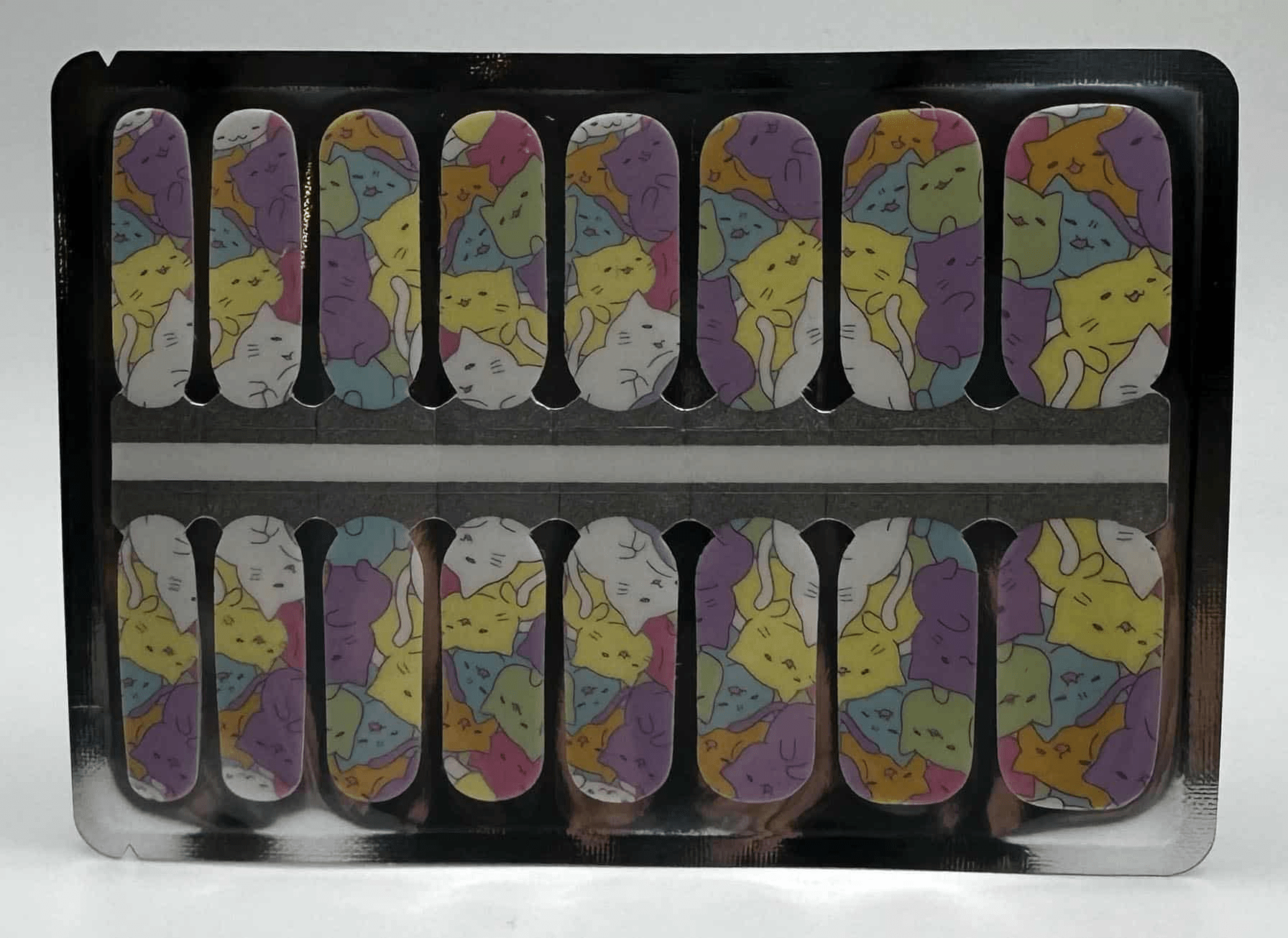 Non-UV nail wraps in packaging featuring cartoon cat design with purple yellow accents