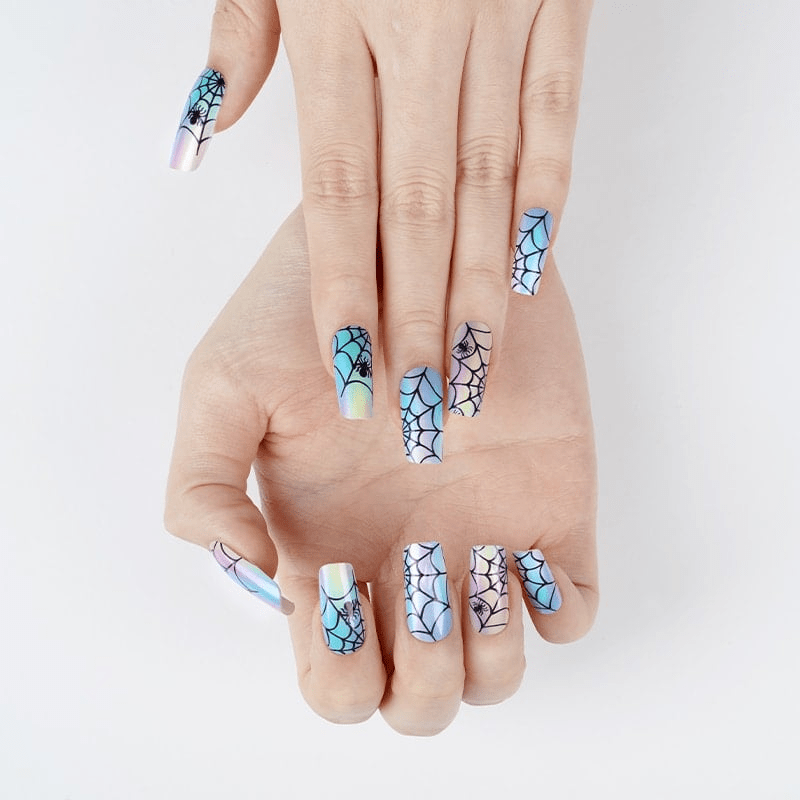 Both hands displaying holographic spider web nail wraps for Halloween gothic manicure