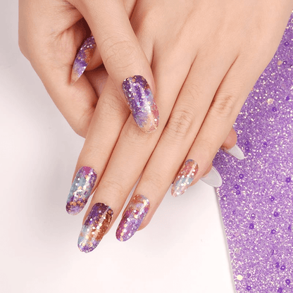 Purple glitter gel nail wraps applied on hand showing sparkly galaxy design