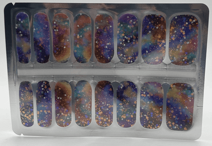 Cosmic glitter nail wraps in packaging featuring purple blue gold sparkle nail art