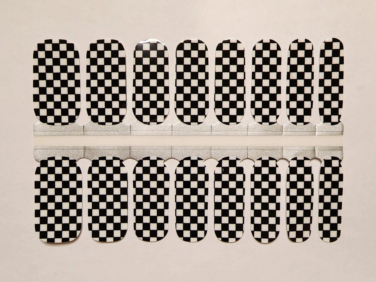 Black and white checkered nail wraps in classic checkerboard pattern for at-home manicure