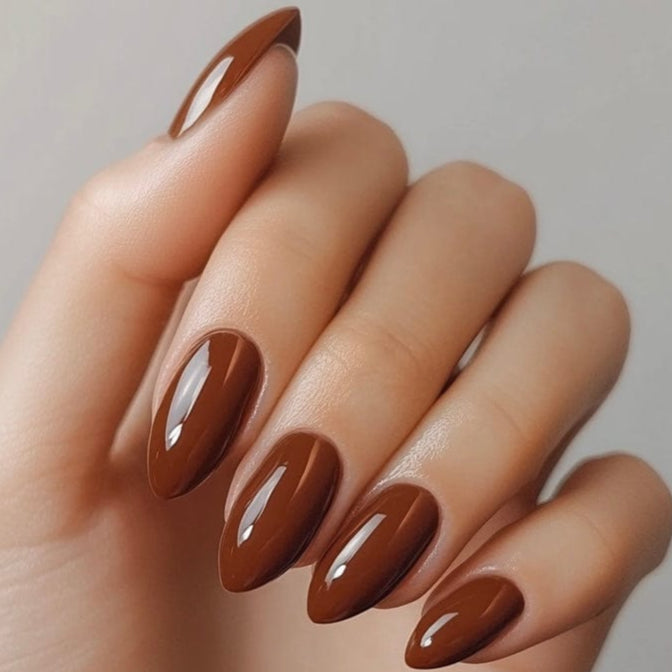 Glossy chocolate brown gel nail wraps on almond shaped nails manicure