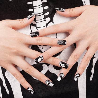 Halloween skull nail art wraps on hands with gothic bone pattern design