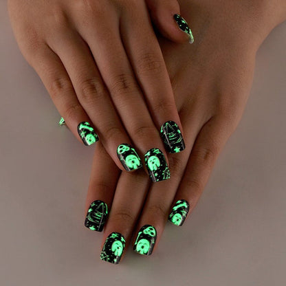 Gothic glow in the dark nail wraps glowing green on hands