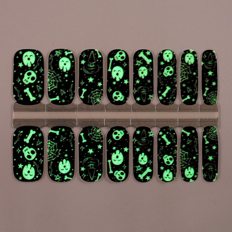 Glow in the dark gothic nail wraps glowing green with skull patterns