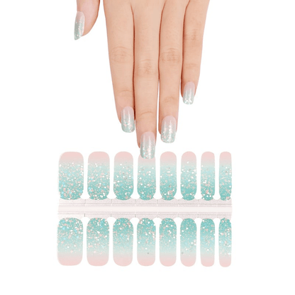 Blue pink glitter nail wrap sheets with hand showing sparkly gradient manicure design