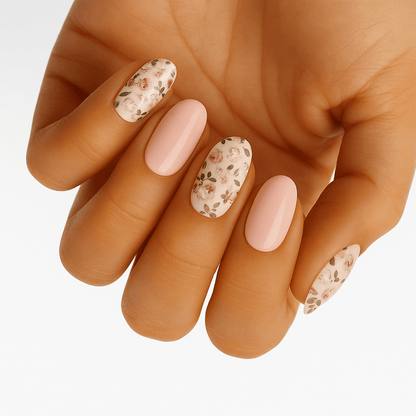 Hand displaying nude pink gel nail wraps with delicate floral pattern at-home manicure