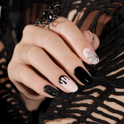 Gothic manicure with black and pink Halloween nail wraps showing spider web designs