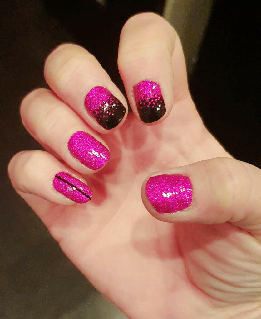 Pink glitter black gradient gel nail wraps on hand showing at-home manicure design