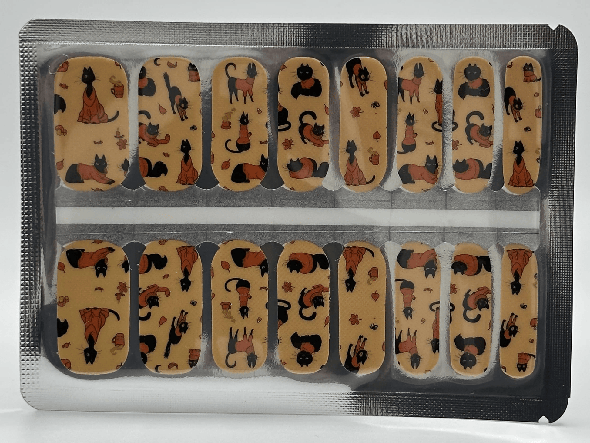 Complete set of orange cat-themed nail wraps displayed in packaging for DIY manicure