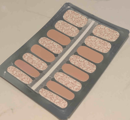 Lace pattern nail wrap strips in nude and white for at-home manicure
