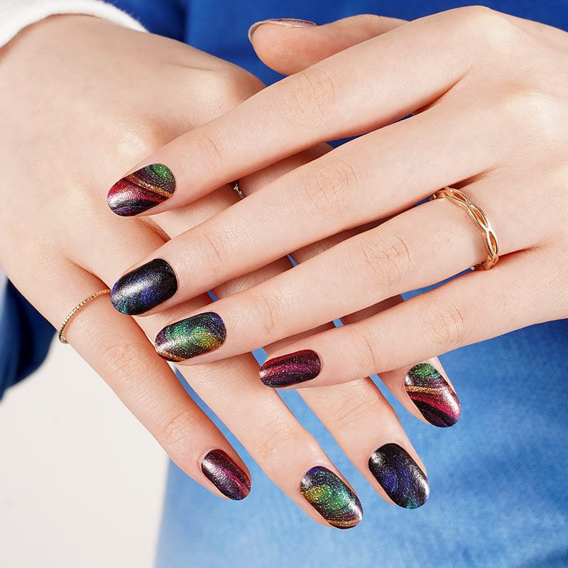 Shimmering multi-coloured nail wraps with holographic rainbow effect on hands