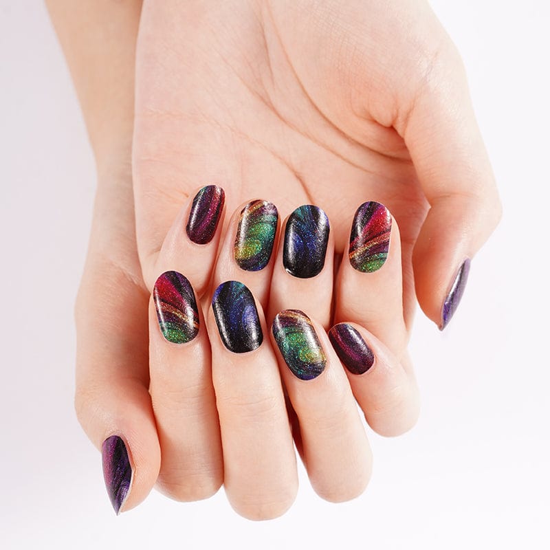 Dark iridescent nail wraps with rainbow chrome finish on manicured hands