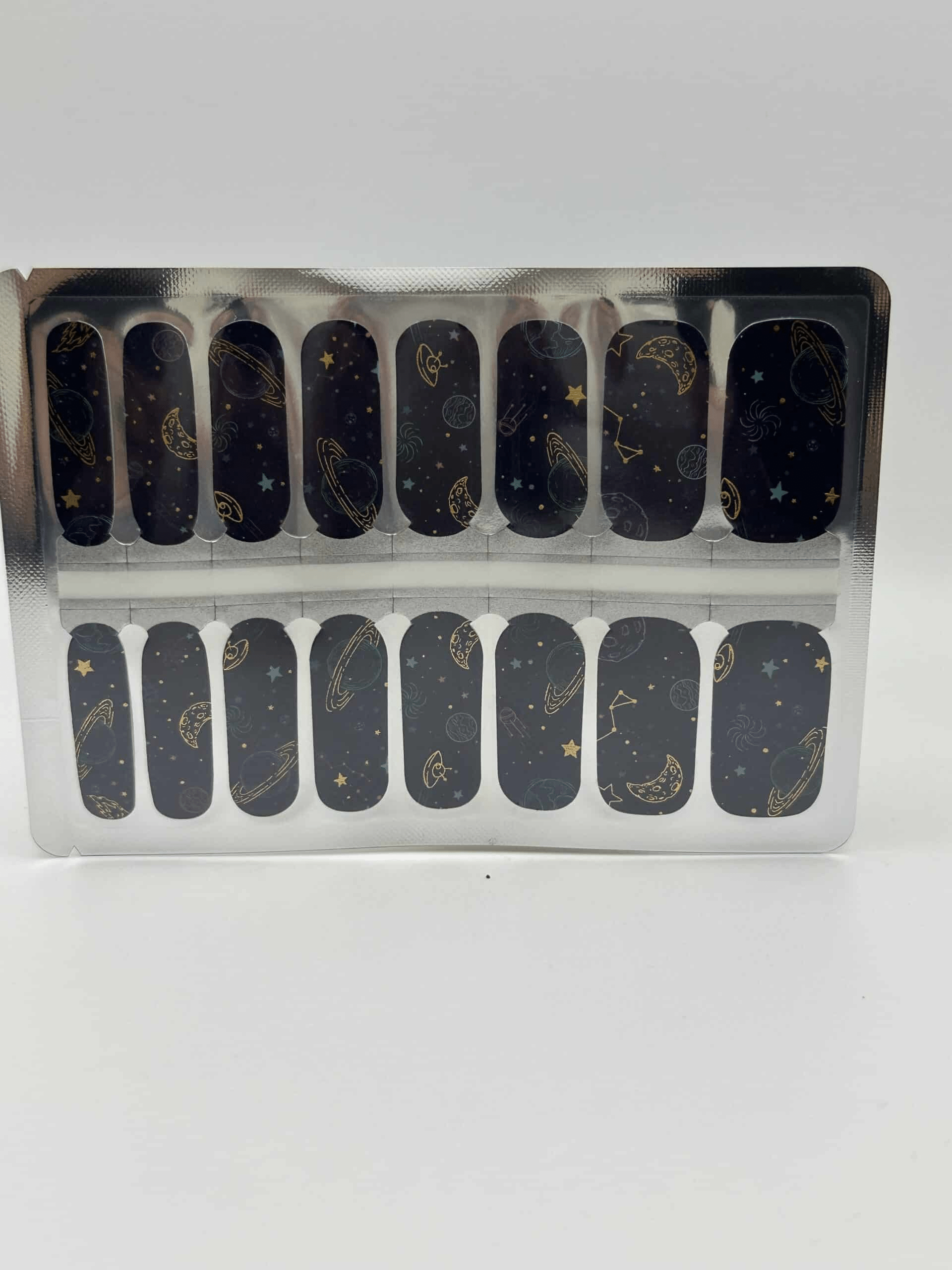 Deep space nail wraps sheet featuring dark blue cosmic pattern with planets and stars