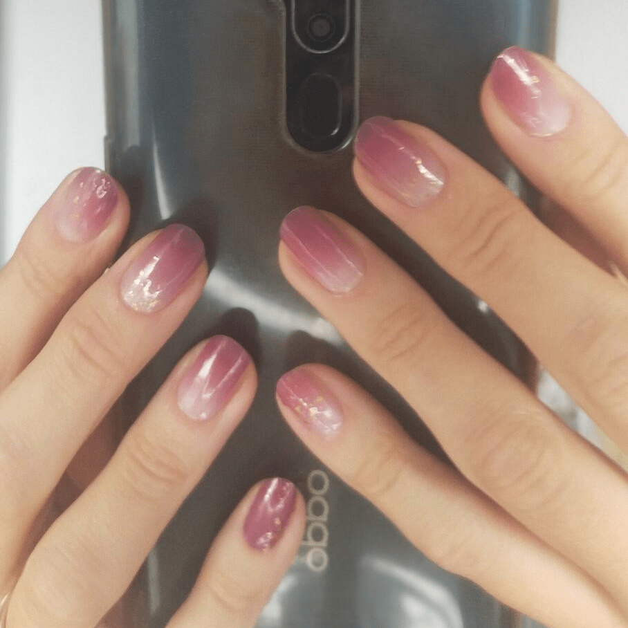 Rose gold shimmer non-UV nail wraps with holographic glitter on hands