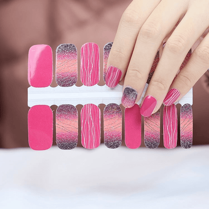 Pink and glitter nail wraps with diagonal stripe pattern displayed on sheet and hand