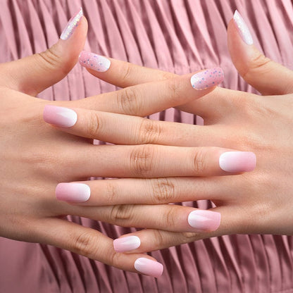 Feminine pink pearl nail wraps on clasped hands showing soft glitter manicure for bridal look