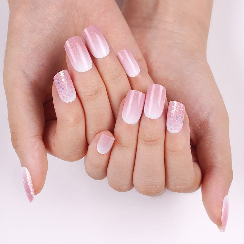 Pink glitter and pearl nail wraps on hands displaying romantic shimmer manicure for wedding nails