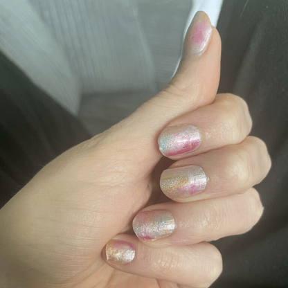 Hand wearing pastel watercolour nail wraps with pink and cream ombre gradient effect