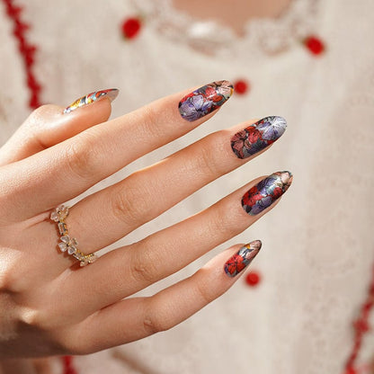 Close-up of floral nail wraps featuring purple coral flower pattern on manicured hand
