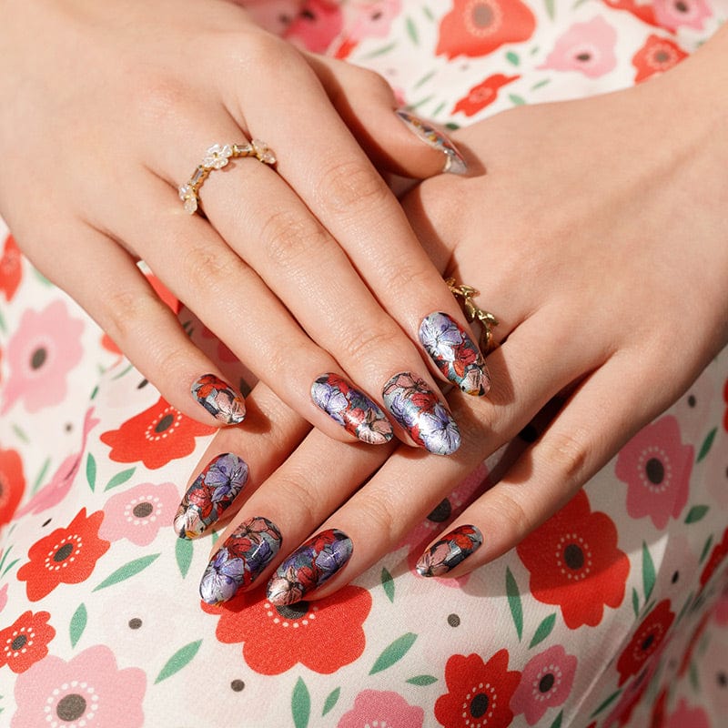 Hands wearing vintage floral nail wraps with purple coral botanical pattern at-home manicure