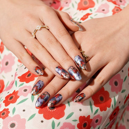 Hands wearing vintage floral nail wraps with purple coral botanical pattern at-home manicure