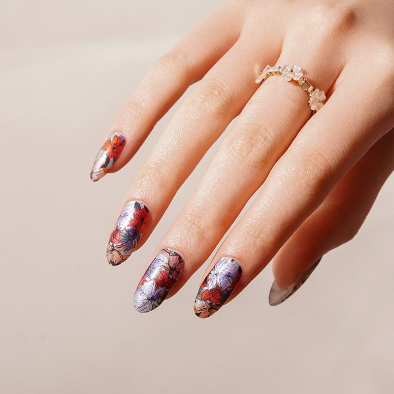 Elegant hand showing botanical nail art wraps with vintage floral design purple coral