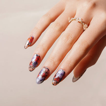 Elegant hand showing botanical nail art wraps with vintage floral design purple coral