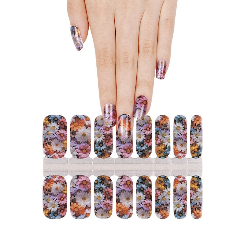 Hand selecting multicolour floral nail wraps from sheet watercolour flower design