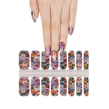 Hand selecting multicolour floral nail wraps from sheet watercolour flower design
