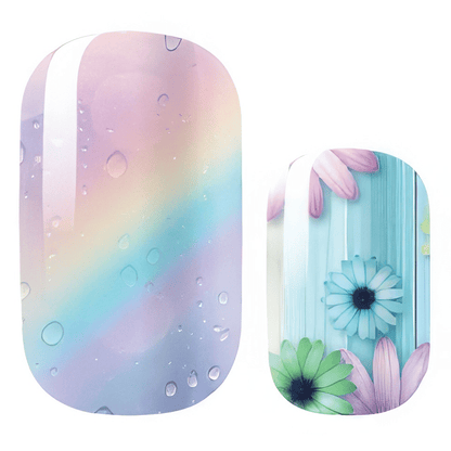 Rainbow gradient nail wraps with water droplets and blue daisy floral accent nail art
