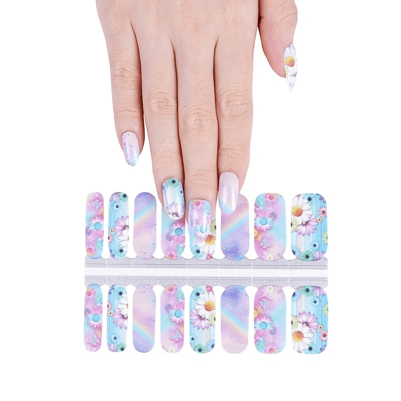 Hand above nail wrap strips showing pastel floral watercolour designs for at-home manicure